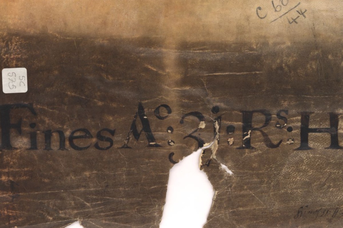 A damaged medieval parchment with bold Latin script, featuring a large tear and faded ink, part of a Fine Roll from 1246.